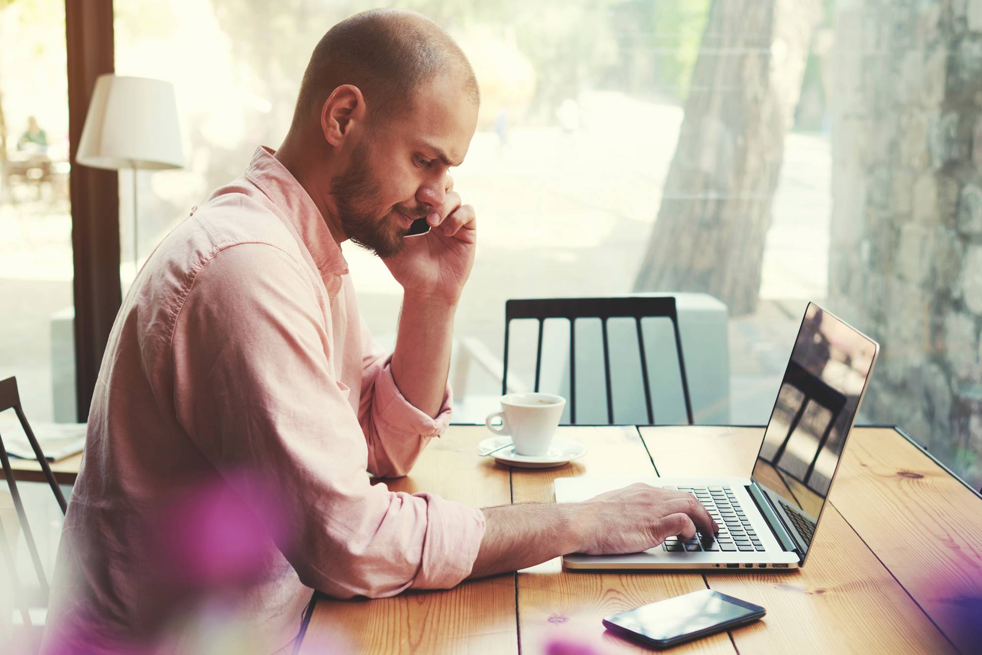 business-man-talking-on-smart-phone-and-look-to-laptop-screen-55409643.jpg