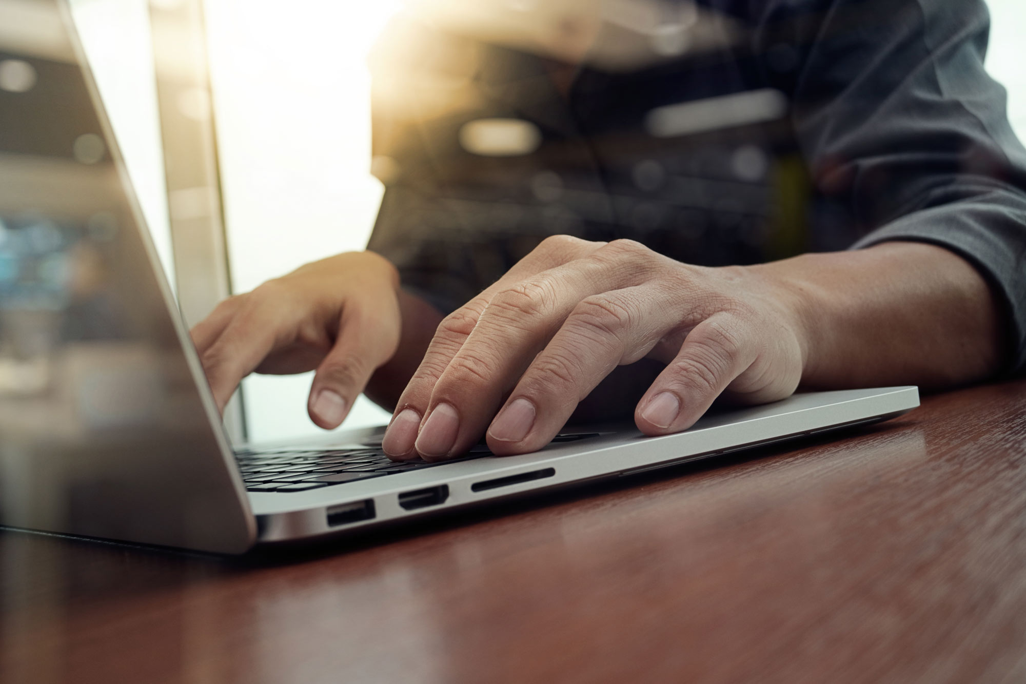 business-man-hand-working-on-laptop-computer-58861196.jpg